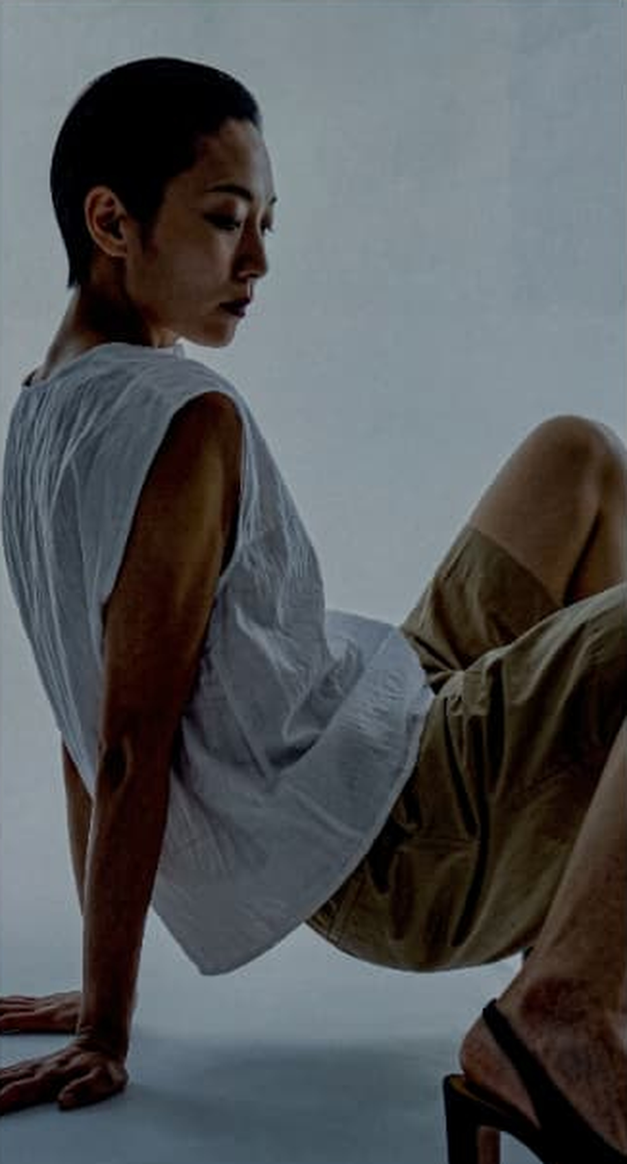 Seated fashion portrait in a pale studio