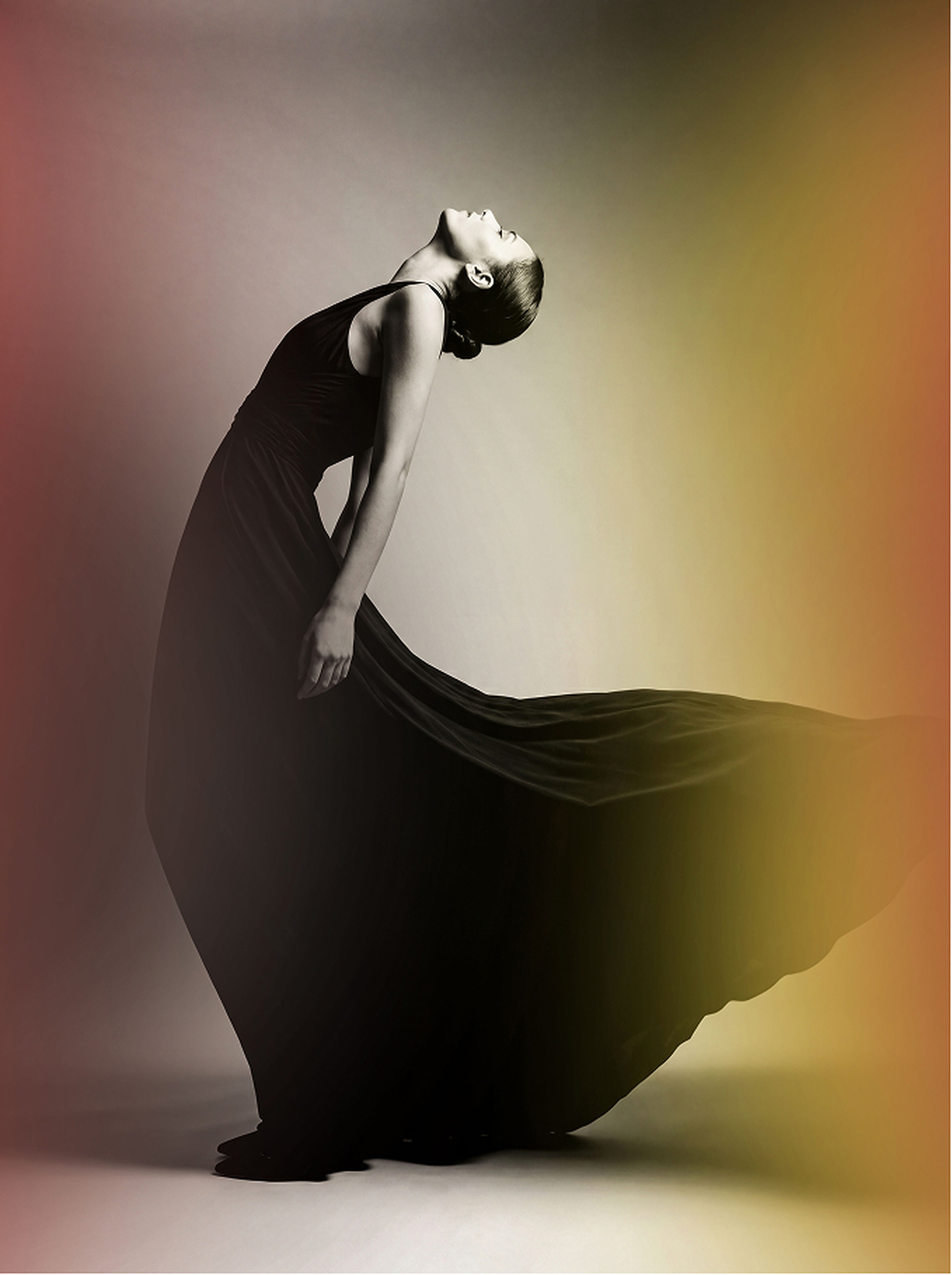 Dancer in black gown against painterly backdrop